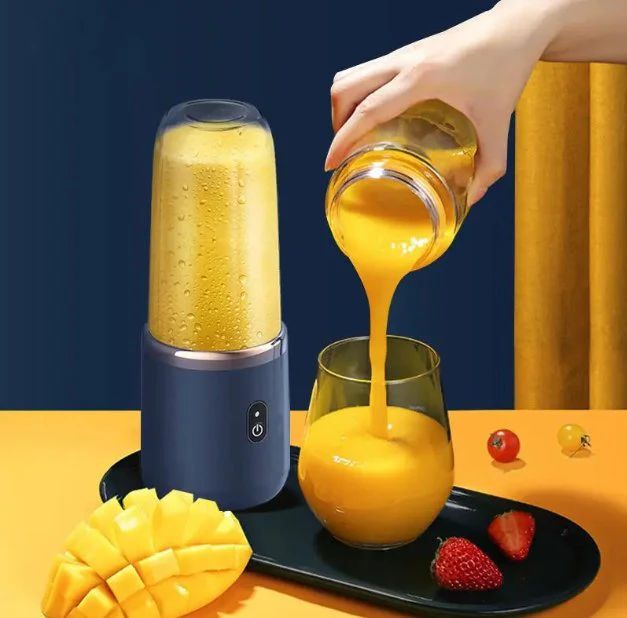 Hand pouring orange juice from a blender into a glass.