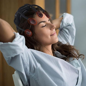 Woman with hair in rollers wearing a white shirt in a salon setting