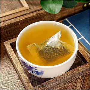 Tea bag in a cup of tea on a wooden tray