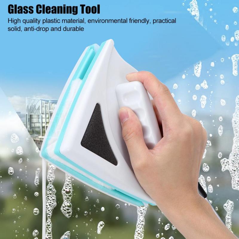Glass cleaning tool with a hand holding it, used to clean a window.
