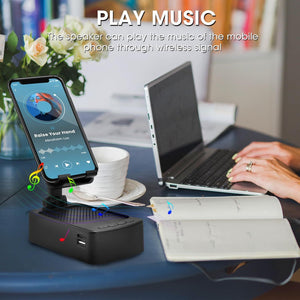 Wireless speaker playing music from a smartphone with a laptop and cup on a desk.